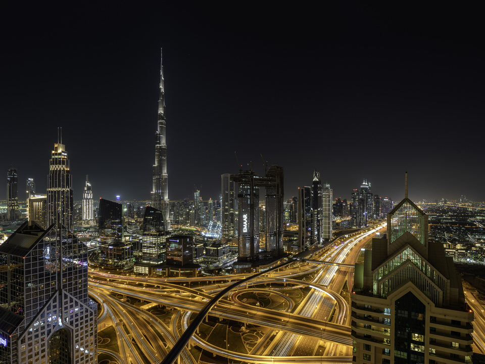 Dubai skyline at night with Burj Khalifa and highways