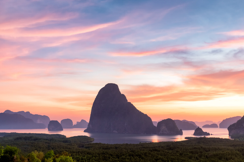 Sunrise over Phang Nga Bay in Thailand with limestone islands and colorful sky