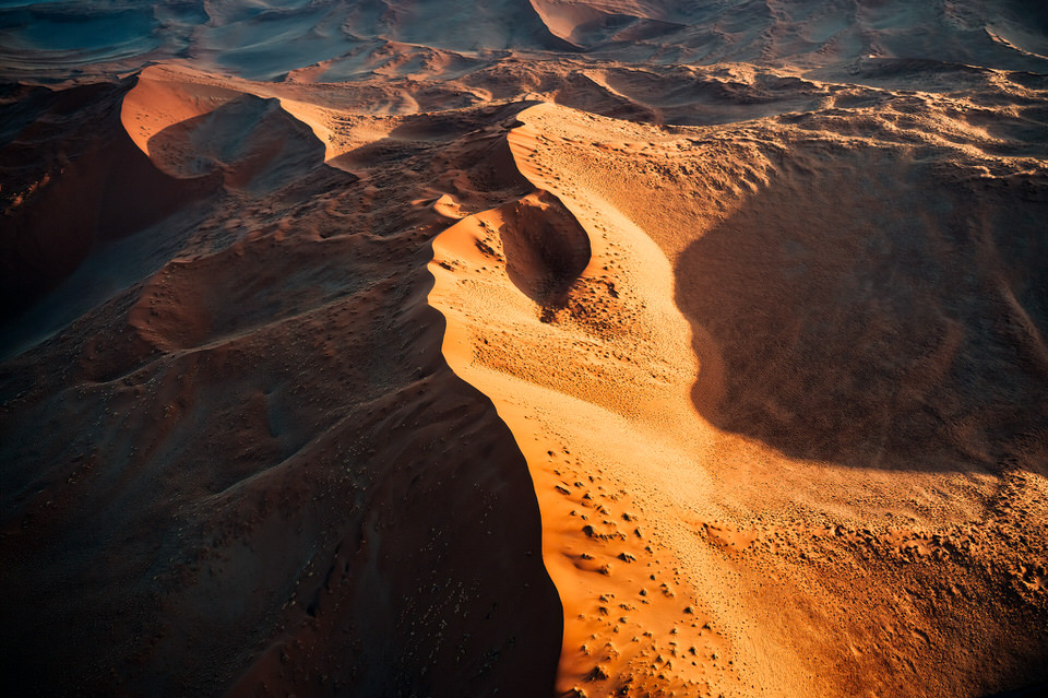 Aerial view of Sossusvlei sand dunes in Namibia with sunrise shadows and patterns